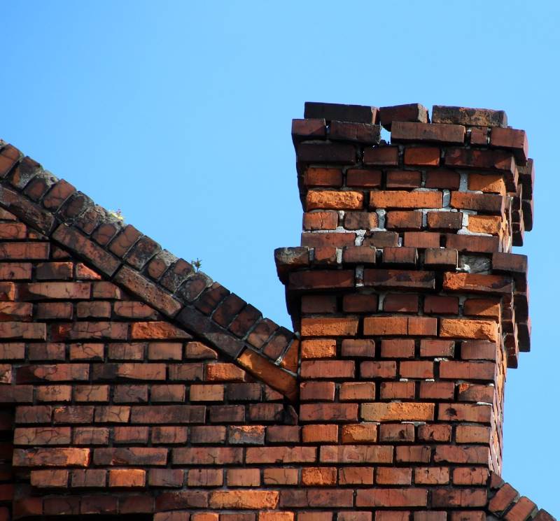 Damaged chimney on an Fountain Valley home showing cracks and missing mortar